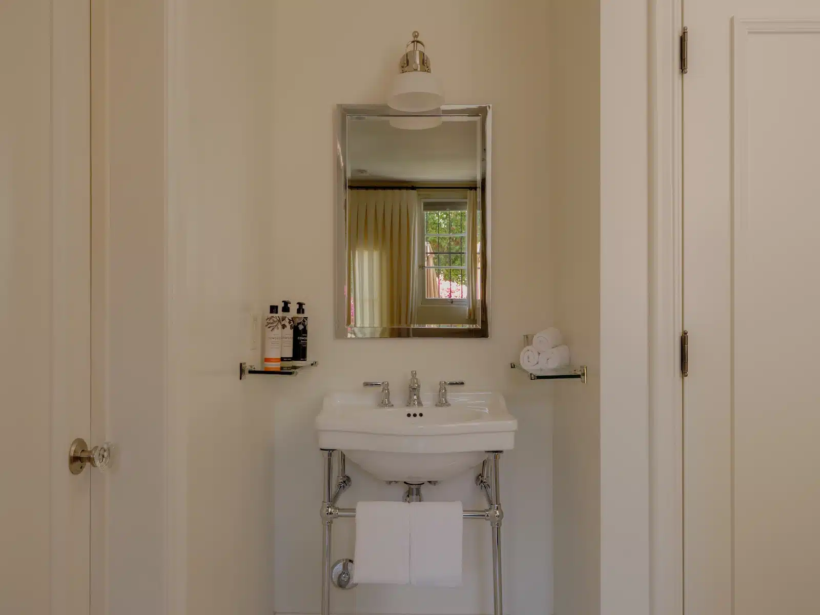 Terrace sink with mirror and bath products on shelf