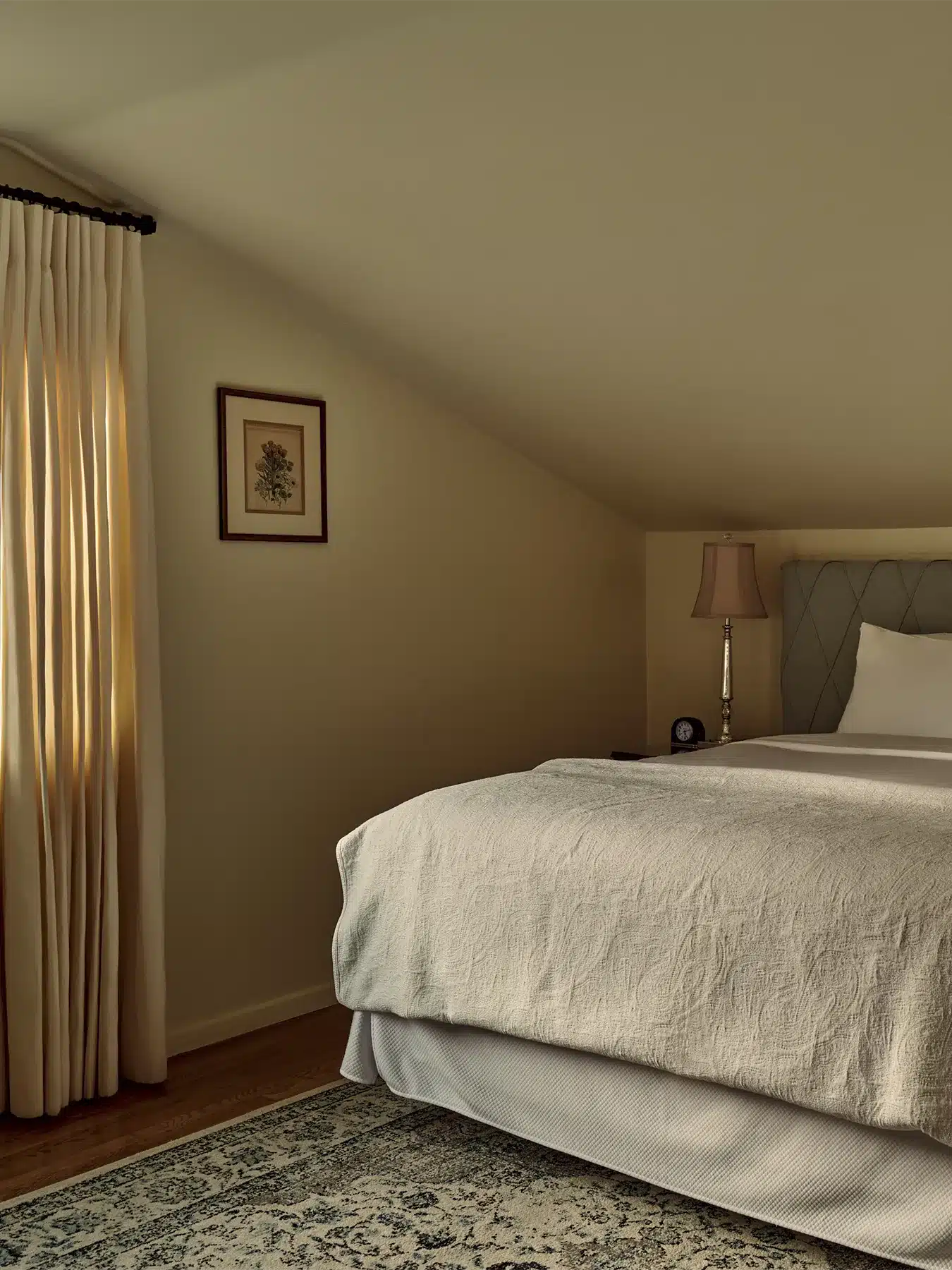 Cielito room bed with side table and privacy curtains