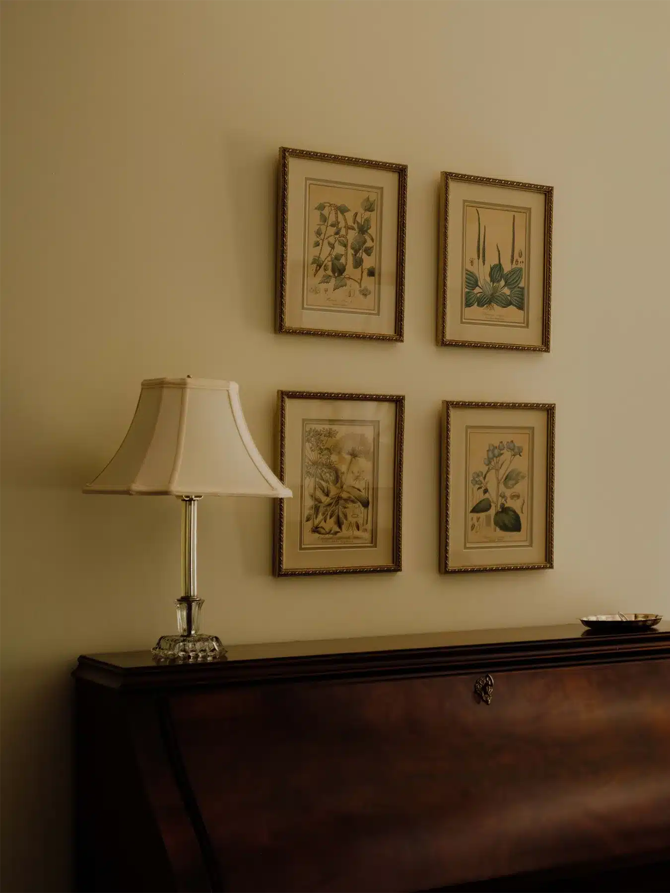 Wall of art work of four framed pictures over desk