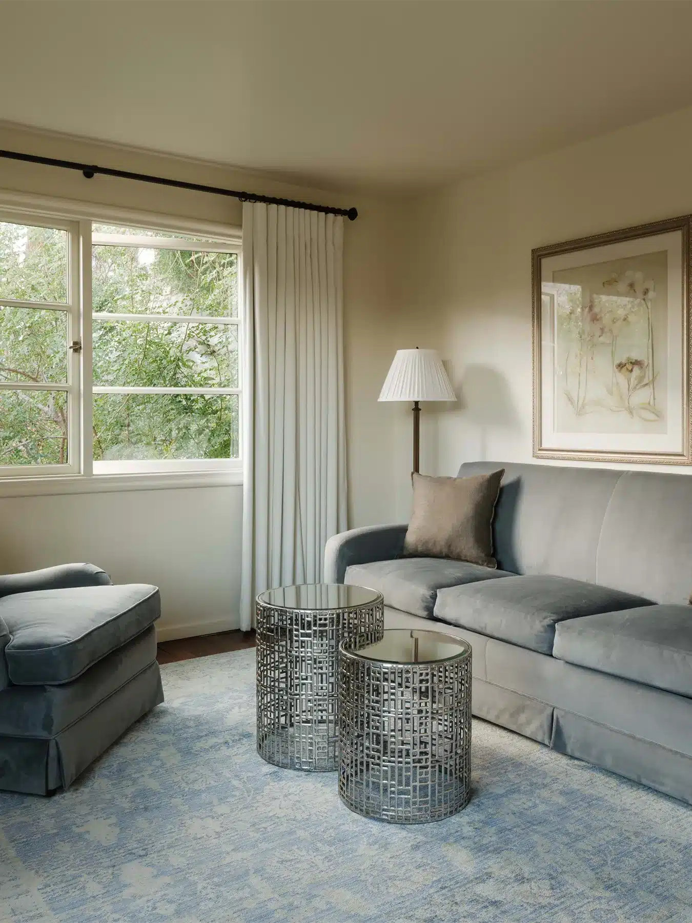 Tahquitz sitting area with two small round tables and chair next to couch