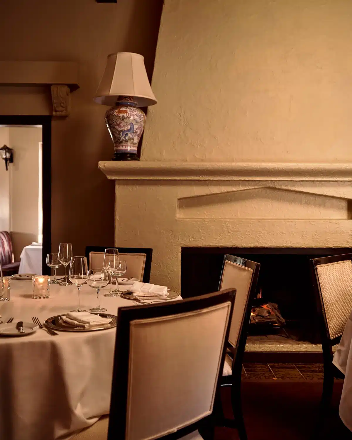 Dining table setting next to fireplace